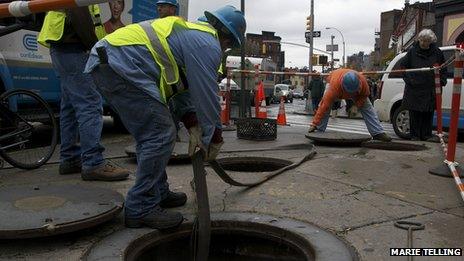 Workers pumping water out of a sewer, New York City, 30 October 2012. Photo: Marie Telling