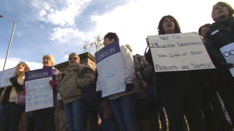 Female hospital workers holding placards in protest