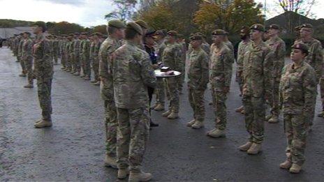 Major General PD Jones presents medals to soldiers from The Royal Anglian Regiment.