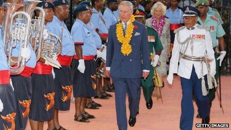 The Prince of Wales inspects a guard of honour as the Duchess of Cornwall looks on at Jacksons International Airport, Papua New Guinea