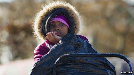 Girl watches over donated bag of clothing, Rockaways, Queens, New York (4 November)