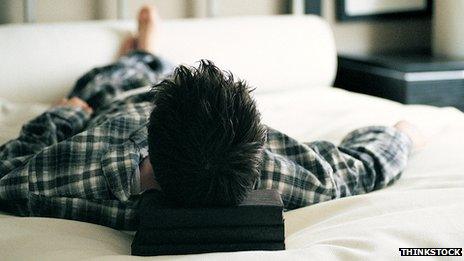 Man lying on double bed