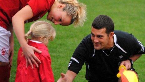 Young Forest player shakes hands with an official