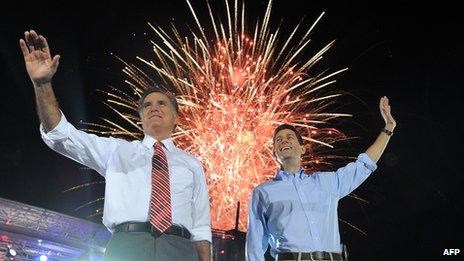 Mitt Romney and Paul Ryan campaigning together with fireworks going off behind them