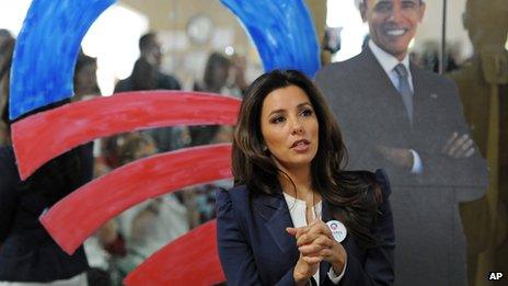 Actress Eva Longoria in front of a cut-out of President Obama