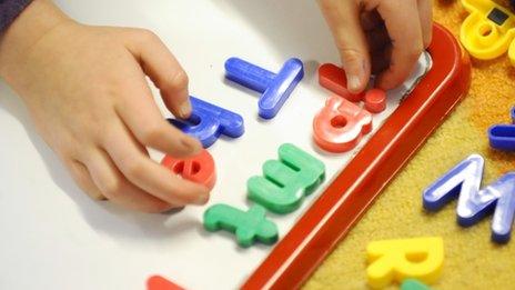 Child playing with letters