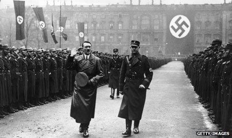 Hitler walking through a guard of honour