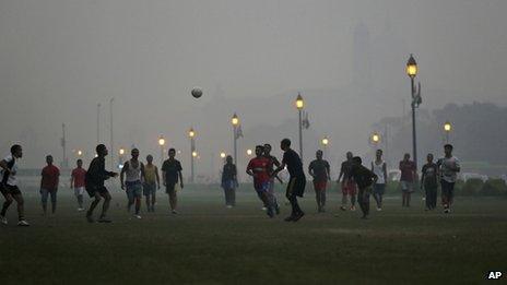 Boys play soccer at a park enveloped by a blanket of smog, caused by a mixture of pollution and fog, in New Delhi, India, Tuesday, Nov. 6, 2012.