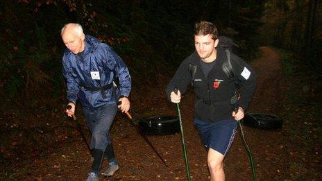 Polar guide Geoff Somers training with Henry by pulling tyres behind them in the Lake District