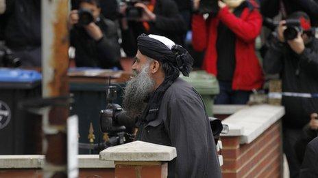 Abu Qatada arrives back at his home in London