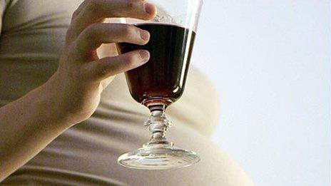 Pregnant woman with glass of wine