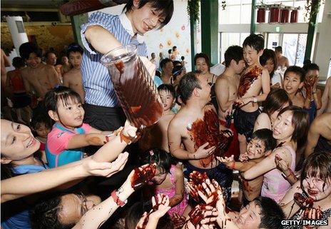 Visitors enjoy the chocolate-spa pool at the Hakone Kowakien Yunessun hot springs resort, Japan