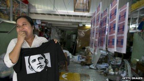 Kyu Kyu Mar, owner of Super silk screening shop, holds a T-shirt printed with an image of US President Barack Obama in Rangoon, Burma, 16 November 2012