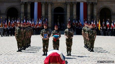 French soldiers honour the coffin of General Bigeard at a ceremony at Les Invalides in Paris