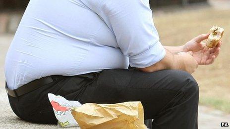 An overweight man eating