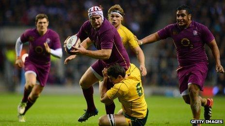 Thomas Waldrom of England is tackled by Dave Dennis of Australia during the game at Twickenham on 17 November