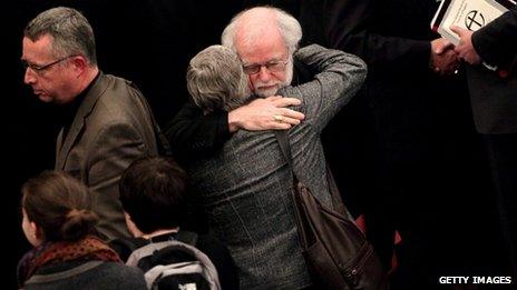 Archbishop of Canterbury Rowan Williams hugging a woman