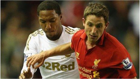 Joe Allen holds off Swansea's Jonathan de Guzman