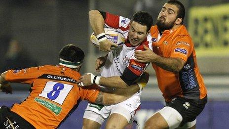 Ulster centre Paddy Wallace is tackled by two Treviso players