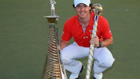 Rory McIlroy with Race to Dubai trophy (left) and DP World Tour Championship trophy