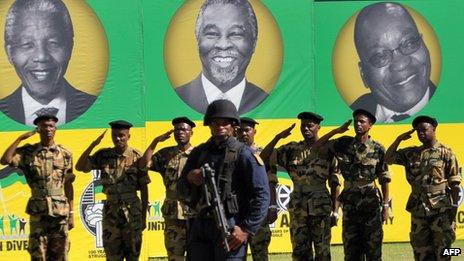 Former ANC soldiers in front of portraits of Nelson Mandela, Thabo Mbeki and Jacob Zuma in Bloemfontein South Africa (January 2012)