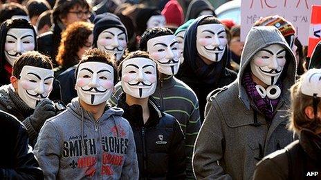 Demonstrators wearing Anonymous Guy Fawkes masks during a protest