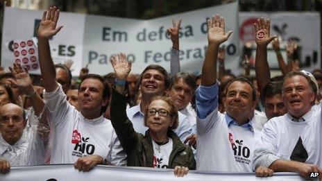 Rio de Janeiro's Governor Sergio Cabral, second from right, Brazilian actress Fernanda Montenegro, centre, and Rio de Janeiro's Mayor Eduardo Paes, second from left, lead a march in Rio de Janeiro