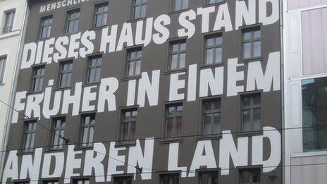 A building in Berlin's tech district with 'this house used to be in another country' painted on it