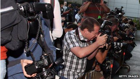 Photographers await the arrival of David and Victoria Beckham in Los Angeles