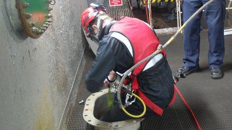 A member of the Deep Rummage Team entering a tank in a training exercise