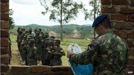 An EU training officer sets up training props for Somali troops at a military academy in Uganda, May 2012