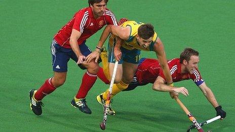 Australia's Eddie Ockenden is challenged by England's Adam Dixon and Dan Shingles