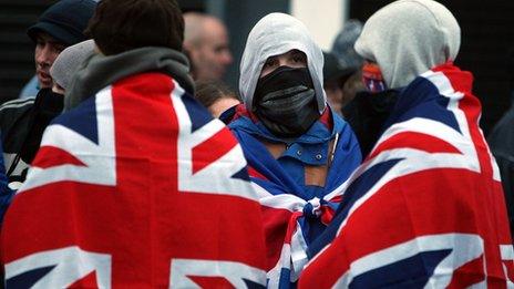 Loyalists in flags and face masks