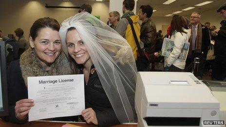 Jeri Andrews (L), 43, and Amy Andrews 33, hold up their marriage license in Seattle on 6 December 2012