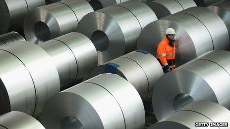 Man wanders among rolls of steel