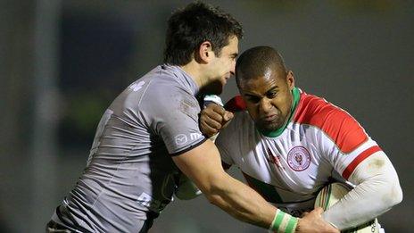 Connacht's Tiernan O'Halloran tackles Aled Brew of Biarritz