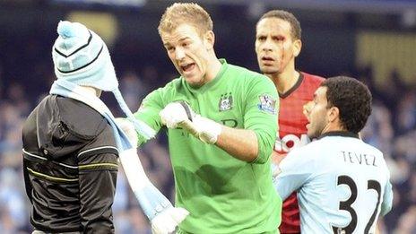 Matthew Stott (left) is stopped from reaching Rio Ferdinand by Joe Hart