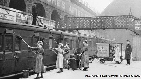 Women workers using an industrial vacuum cleaner to clean railway carriages at London Bridge Station, 1918