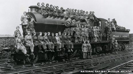 Women locomotive cleaners sitting on an engine, Bradford, West Yorkshire, 23 March 1917