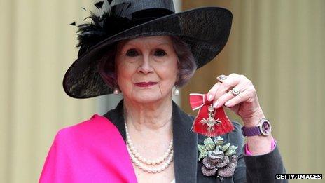 April Ashley holds her MBE medal