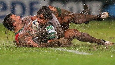 Damien Traille tackles Mike McCarthy at a rain-lashed Parc des Sports Aguilera in Biarritz