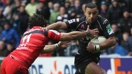 Ospreys wing hands off Yoann Huget of Toulouse to score