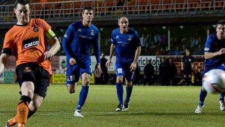 Jon Daly netted a stoppage-time penalty to save a point for Dundee United