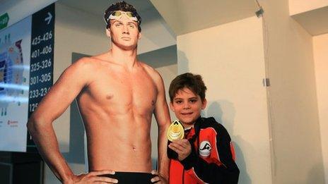 Fan with a medal from Ryan Lochte