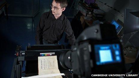 Imaging technician photographing Isaac Newton's Principia for the Cambridge Digital Library