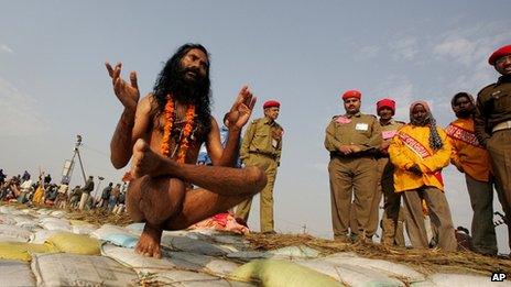 A Naga Sadhus, or Hindu holy men, performs yoga postures after taking a holy dip at the confluence of the Rivers Ganges, Yamuna and mythical Saraswati during the 45-day long Ardh Kumbh Mela festival in Allahabad, India, Monday, Jan. 15, 2007.