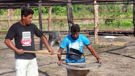 Dedel and colleague working on their land