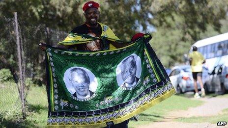 A street vendor sells African National Congress (ANC) wraps with portraits depicting former South African President Nelson Mandela prior to the opening of the 53rd National Conference of the ANC on 16 December 2012