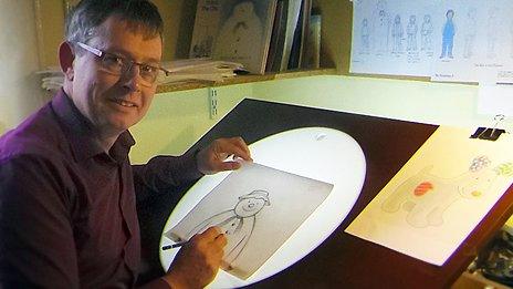 Roger Mainwood drawing The Snowman on a light-box