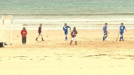 Shinty played on beach